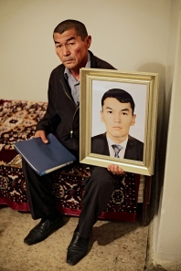 LOSS: Shetpe is a small town in the middle of a desert, 150 kilometers to northwest from Zhanaozen. Zhanibek Tolegenov, 55, is holding a picture of his son who died by police bullets. Day afer the massacre in Zhanaozen, special force police opened fire against civilians in a train station at Shetpe. Torebek Tolegenov, 30, was a firefghter, who tried to calm the riot police to not to use weapons against civilians. Shootings lasted in from a midday till late night. Zhanibek Tolegenov got hits in his car too while he was urging to a hospital where his son died for several injuries.